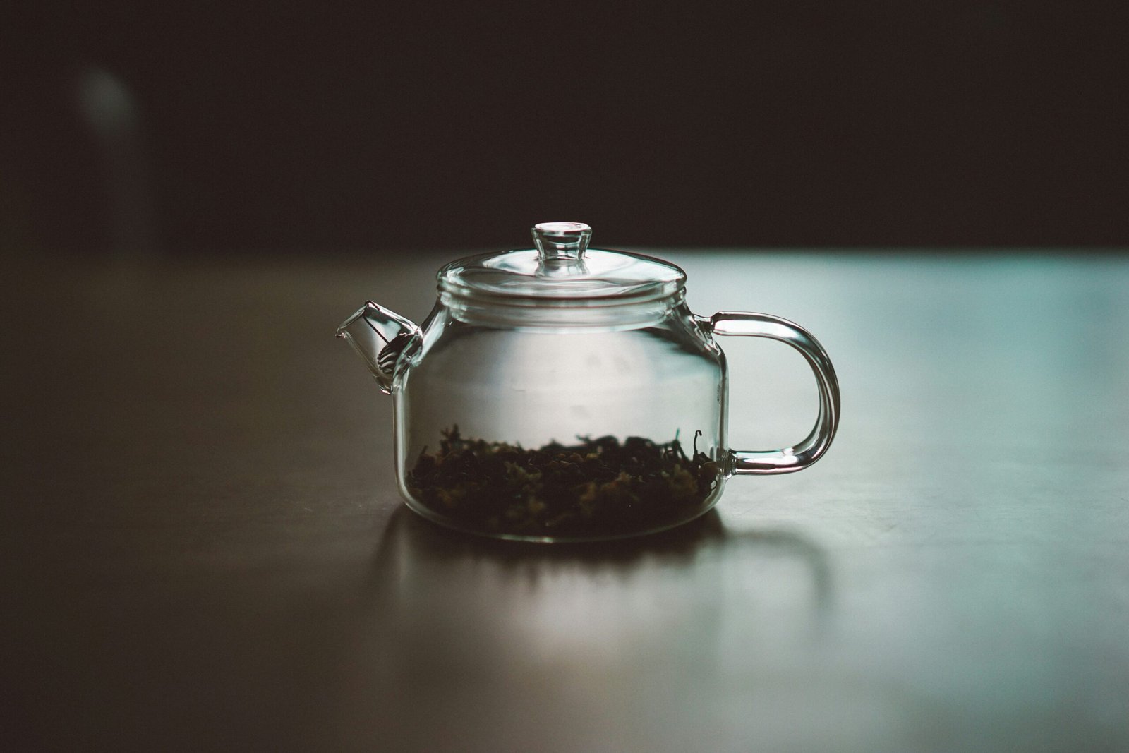 Steaming mug of red clover tea garnished with mint leaves