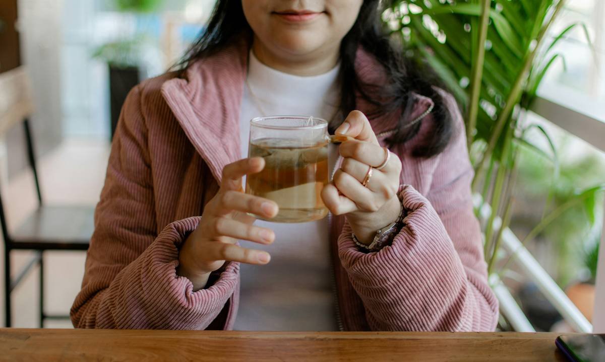 A close-up photograph of bright purple flowers of red clover growing in a meadow.