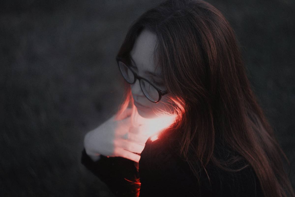 Woman fanning herself during a hot flash at work