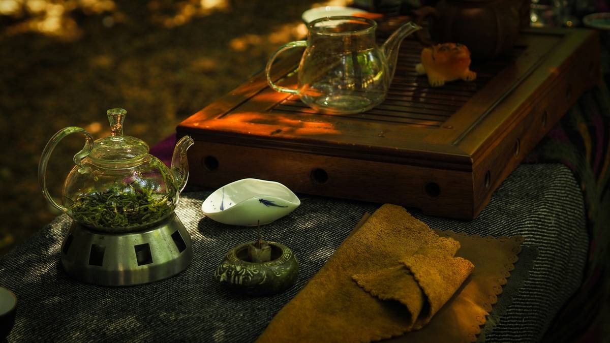 Woman smiling while drinking red clover tea at sunrise